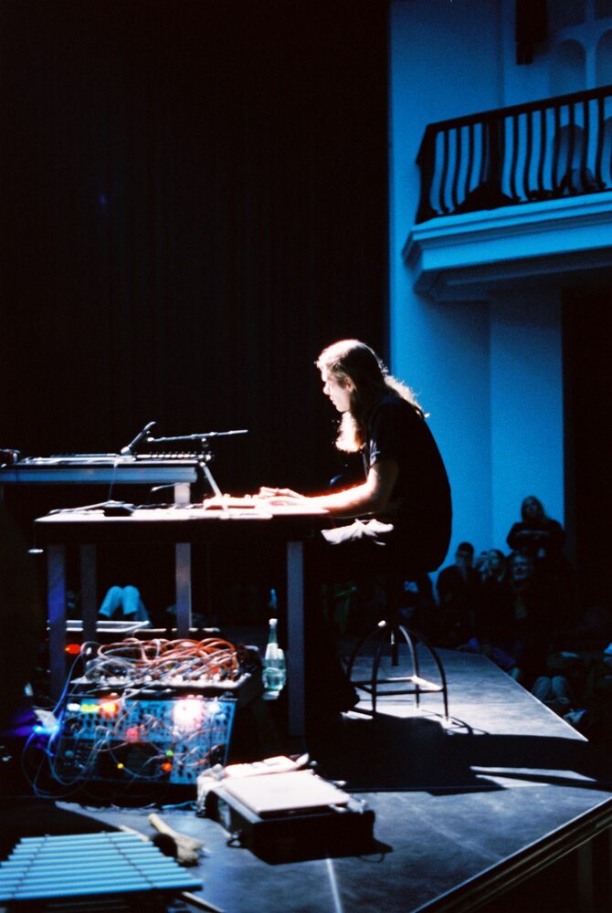 Side view of performer on stage, above the audience