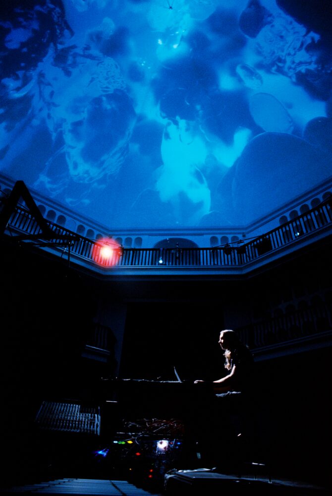 Amedeo Cappelletti performing live, blue projection
