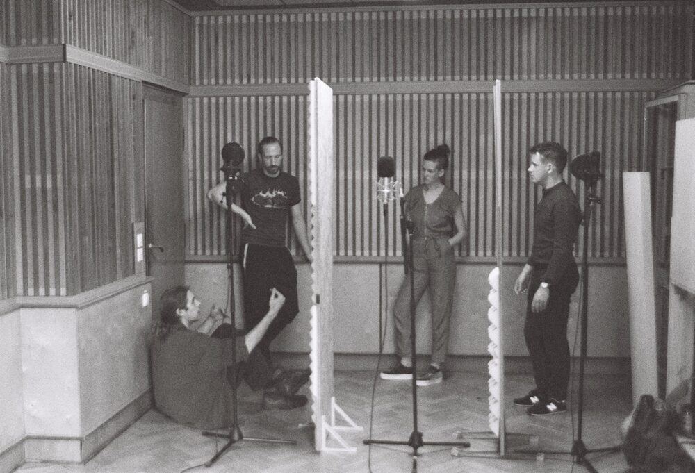 Monom, vocal booth session, three people recording behind acoustic baffles
